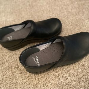 New, never worn Dansko women’s clogs, size 39, black.